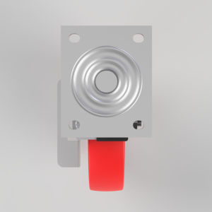 Close-up of a metal circular actuator mounted on a gray panel, with a red safety lever beneath.