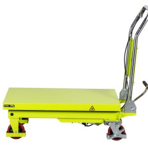 Yellow mobile hydraulic lift/table with red wheels and a lime-green platform, showing a load limit label (Q max. 300 kg) and safety symbols on the side panel.